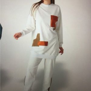 Oversized sweatshirt and pant set with design.